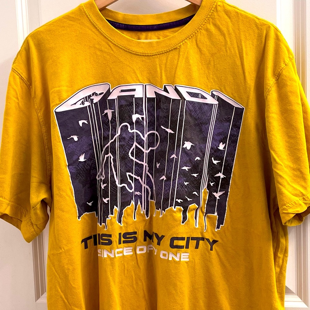 Yellow T-shirt that says this is my city since day one it is in A size large